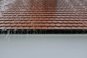  a heavy rain sliding down a roof
