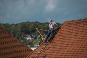 A worker handling roof repairs