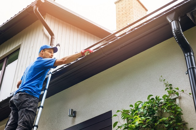 Person on a ladder to reach a roof